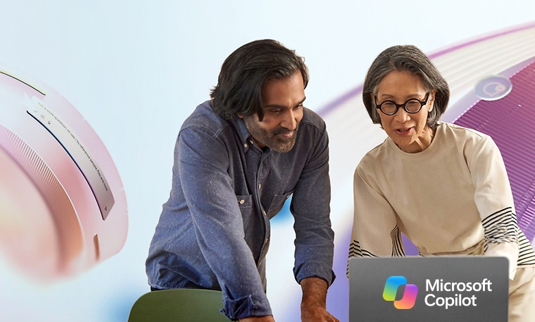 Man and woman in front of Microsoft laptop
